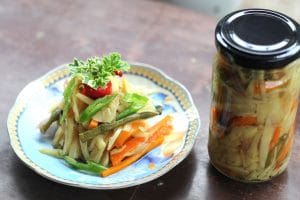 Edible bamboo shoots on a plate and canned in a glass jar