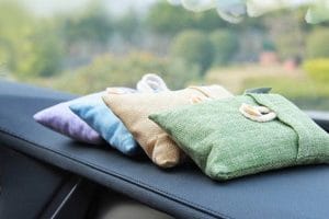 Four colorful bamboo charcoal bags on a car console