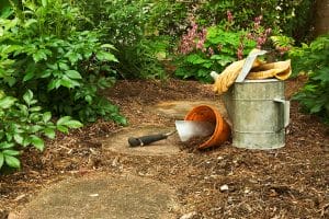 Bamboo mulch in a garden with gardening tools