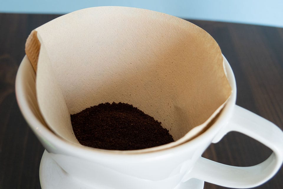Coffee grounds in a fresh bamboo coffee filter