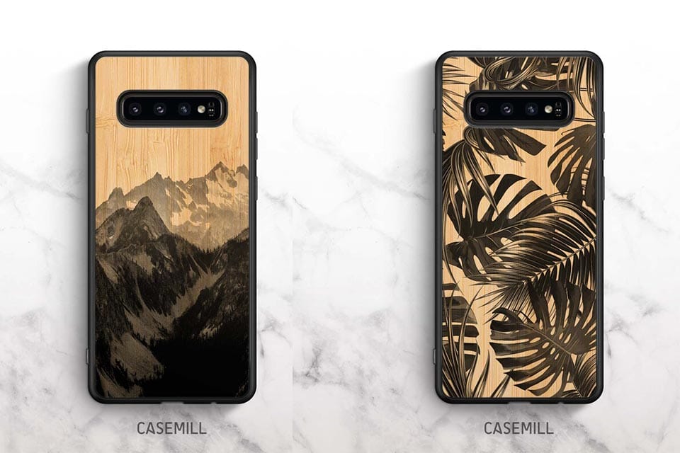 Two bamboo phone cases with black & white designs of mountains and tropical leaves