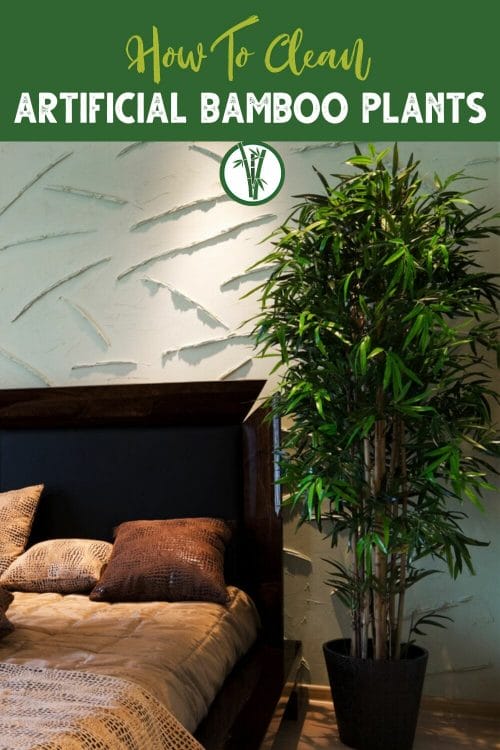 Artificial bamboo plant in a big pot, positioned next to a bed with a text above: How To Clean Artificial Bamboo Plants