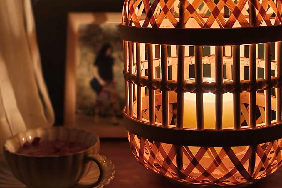 Candle creating warm light in a bamboo lantern which is a great bamboo garden decor