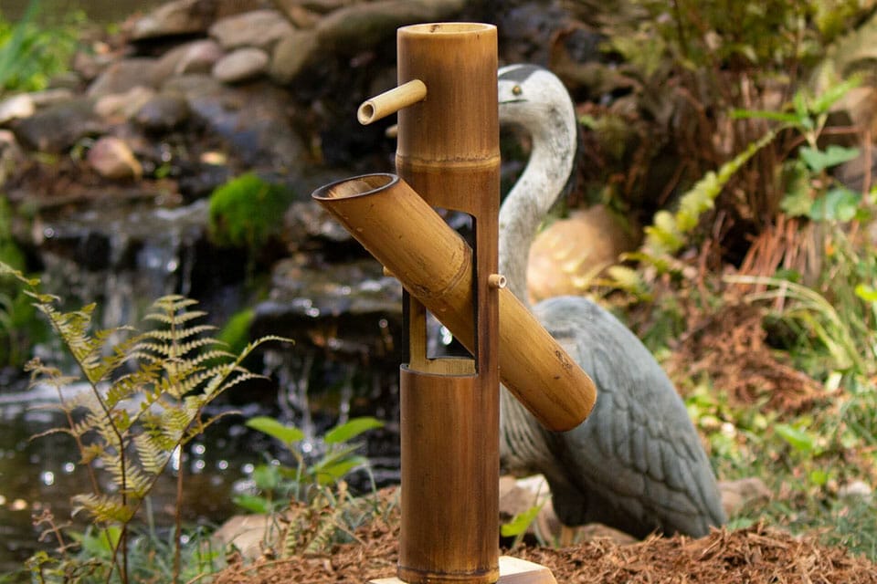 Bamboo water feature in a backyard is a great bamboo decor for gardens and green spaces
